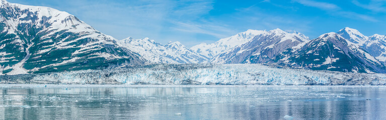 A panorama view across the floating ice of Disenchartment Bay towards the snout of the Valerie Glacier in Alaska in summertime