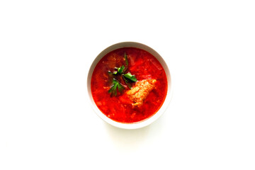 Red borscht in bowl on white background, traditional dish that is cooked with broth. Culture of Ukrainian borscht cooking - intangible heritage.
