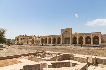 Excavations in historical center of Bukhara. City is so ancient that unexpected finds can be found in most familiar places. Kalyan minaret and old covered bazaar are visible in distance