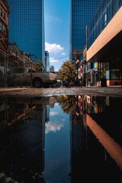 Regina Street Cityscape With Rain Puddle Reflections In Saskatchewan, Canada. Abstract Topography Of The City Roads Under Construction.