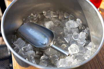 ice cubes with a large spatula in a metal plate