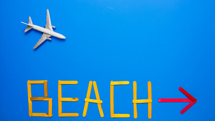 Blue background with toy aeroplane and text  with red arrow