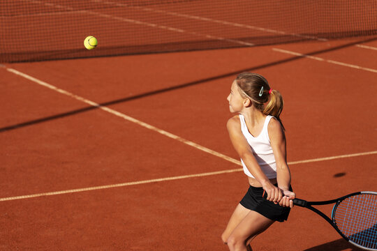 Girl hitting a backhand tennis groundstroke