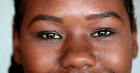 African woman eyes smile casual macro close-up. mixed race girl smiling