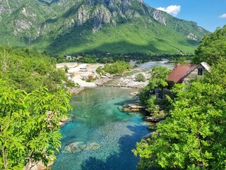 Fototapeta na wymiar Mountain river and village in the mountains in Albania