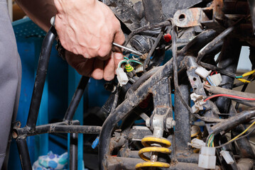 The master conducts disassembly of equipment for maintenance. - obrazy, fototapety, plakaty