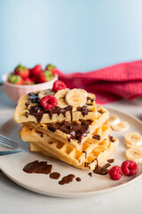 delicious belgian breakfast waffles with strawberries and raspberries and chocolate and banana