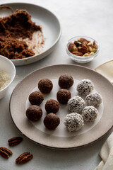 Energy balls. Cooking healthy raw dessert vegetarian candies made of dates, hazelnuts, cocoa powder