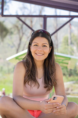 Young woman enjoying the day in a park, in a sporty outfit doing activities and exercises.