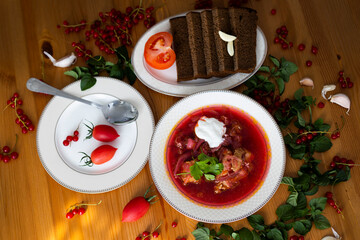 Beetroot soup called borsch with meat, potatos and cabbage and traditional russian black bread or rye bread