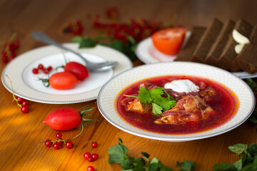 Beetroot soup called borsch with meat, potatos and cabbage and traditional russian black bread or rye bread