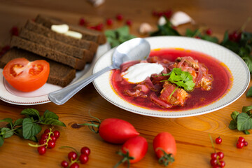 Beetroot soup called borsch with meat, potatos and cabbage and traditional russian black bread or rye bread