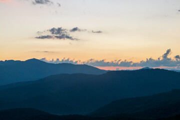 blue ridge mountains at sunset with orange and yellows.