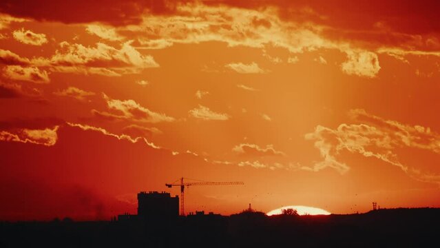 Close up yellow orange red sky the sun goes down sunset twilight. Urban landscape with buildings silhouettes. Evening sky