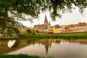 view over the river Danube to the old stone bridge and downtown Regensburg