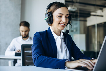 Man and woman working in call center office and consulting people