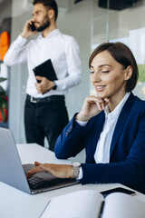 Colleagues working in office on the computer