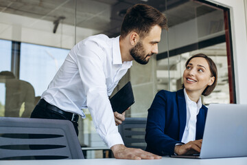 Colleagues working in office on the computer
