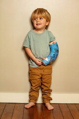 Portrait of a boy with positive expression despite broken hand