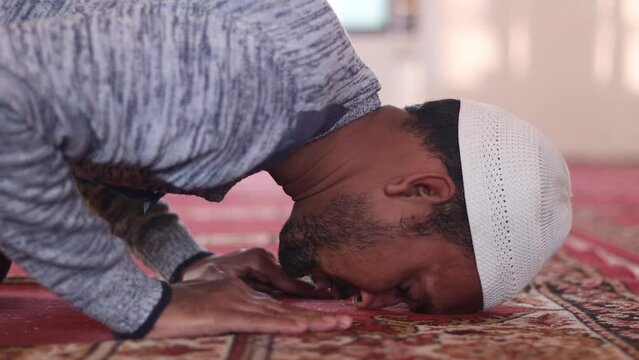young muslim men performing Salah prayer