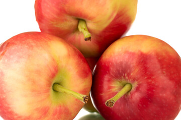 Three red sweet apples , close-up, on a white background.