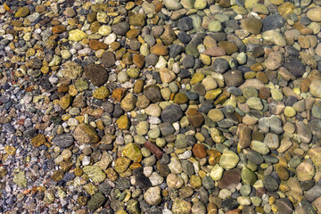 View of underwater pebbles in the sea, pebble background