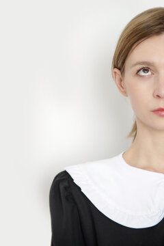 Serie of studio photos of young female model wearing black dress with white peter pan detachable collar.