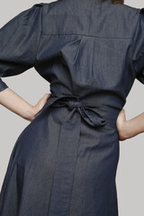 Serie of studio photos of young female model wearing puff sleeved cotton denim dress