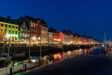 Nyhavn canal with sunset view It is a sightseeing and entertainment district with old ships and colorful houses from the 17th and early 18th centuries. 20 July 2022 Copenhagen, Denmark 