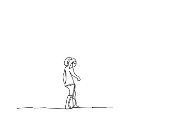 a young woman outside walking thoughtfully looking at the ground