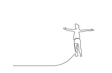 a young man climbs to the top with open arms and looks at the skyline happily and hopefully
