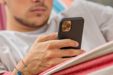 hand of young man with mobile or cell phone