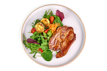 Grilled pork shoulder steak with vegetable salad, isolated on white background.