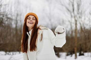 young woman in winter clothes in a hat fun winter landscape Walk in the winter forest