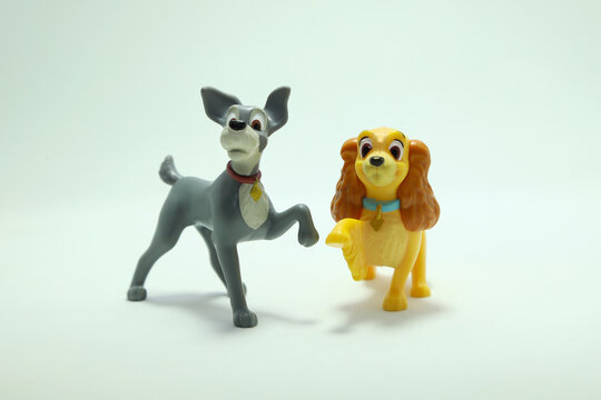 Dogs toys from the movie Lady and the Tramp. Couple of dogs in love. McDonald's happy meal toy in commemoration of the Walt Disney World 50th Anniversary celebration. Isolated white. Pet Plastic doll