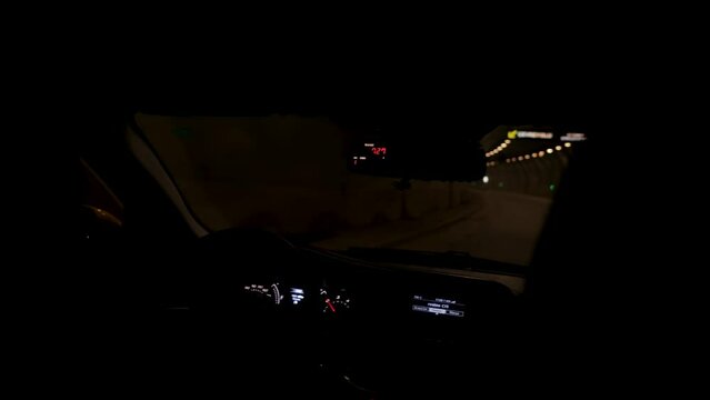 Two men ride in a taxi through a tunnel in Istanbul