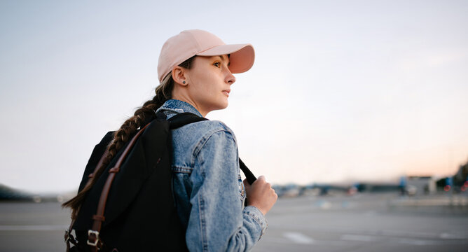Tourist girl with her backpack looking at city landscape, back view Adventure and travel in the concept . Backpack rear view. Tourism in city.