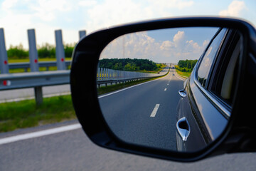 look in the rear view mirror of a car