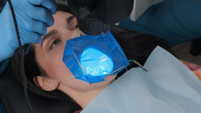 Closeup shot of a woman patient with a cofferdam system in a modern dental office. Dental equipment