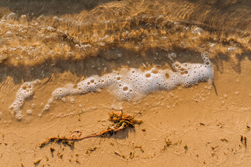 Background, texture of sand and waves on the sea, ocean view from above.