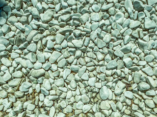 Fototapeta na wymiar texture, small, gray stones lie on the road. material for the construction of roadsides and roads, stones for decorative figures