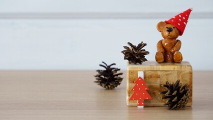 Christmas composition with a ceramic teddy bear a red cap in white polka dots, a red white polka...