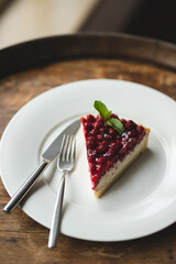 Tart with raspberry coulis. Dessert on a white plate