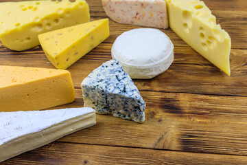 Set of various types of cheese on wooden table