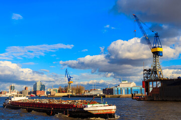 Industrial barge carrying scrap metal for recycling on the river Elbe in Hamburg, Germany