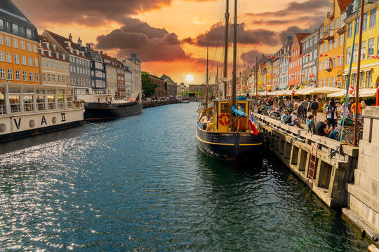 Nyhavn canal with sunset view It is a sightseeing and entertainment district with old ships and colorful houses from the 17th and early 18th centuries. 20 July 2022 Copenhagen, Denmark 
