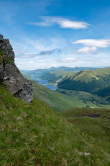 Fototapeta premium Scenic view of lake loch voil from a hill called beinn tulaichean, beautiful green hilly Scottish landscape