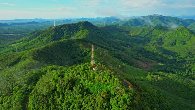 Drone flying over telecommunication towers on green mountain. tropical forest. Khao Ong, Chumphon, Southern Thailand. aerial view from a drone. Green nature background. 4k Footage
