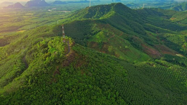 Drone flying over telecommunication towers on green mountain. tropical forest. Khao Ong, Chumphon, Southern Thailand. aerial view from a drone. Green nature background. 4k Footage
