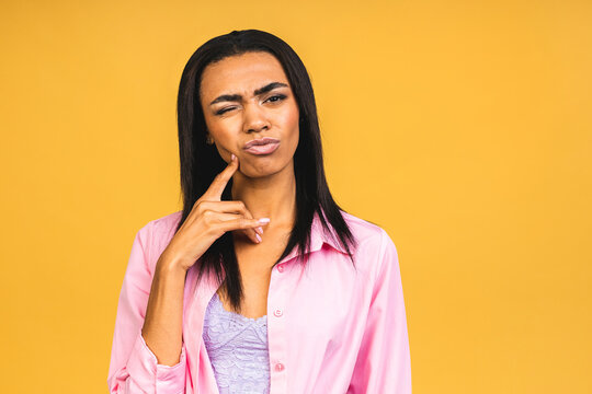 Portrait of african american black woman wearing casual depressed and worry for distress, crying angry and afraid, sad expression. Isolated over yellow background.
